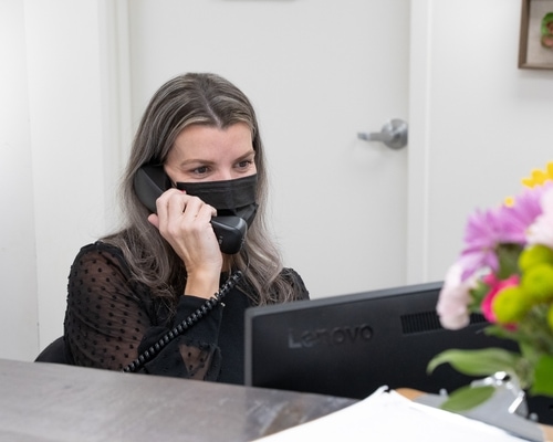 A Bluewater team member takes a call at the clinic reception desk