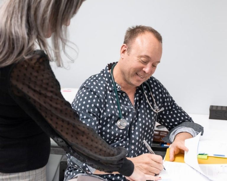 A Bluewater physician takes a participant blood pressure reading during a study visit