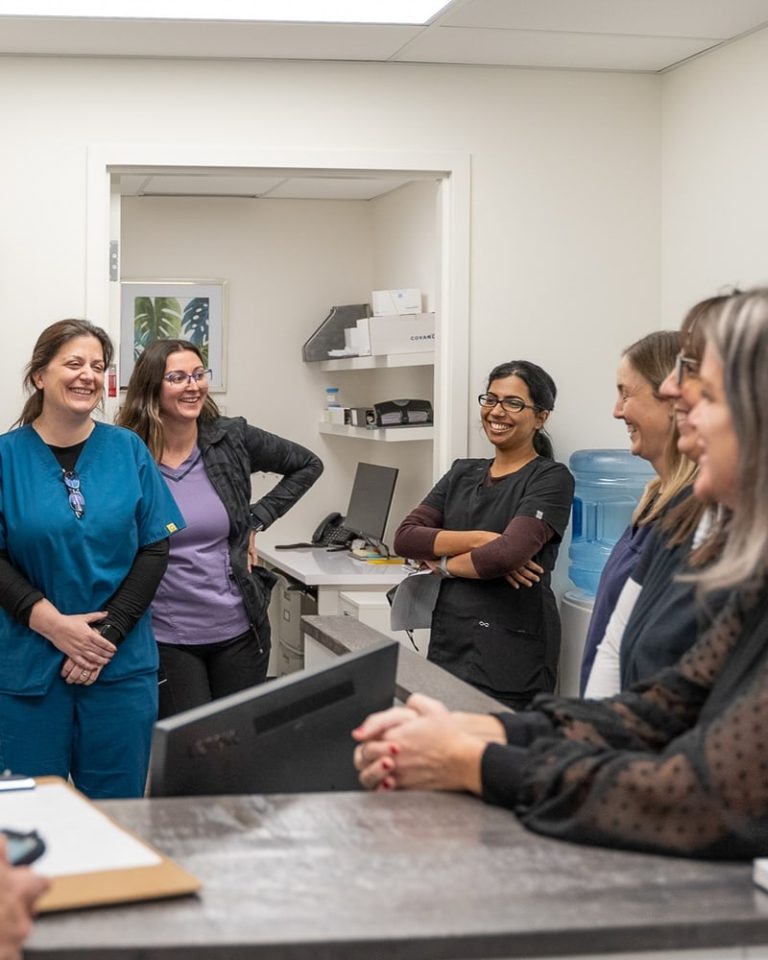 Research nurses and coordinators of the Bluewater team gathered at a workstation in the clinic