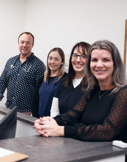 Four members of the Bluewater Clinical Research Group team at the clinic front desk